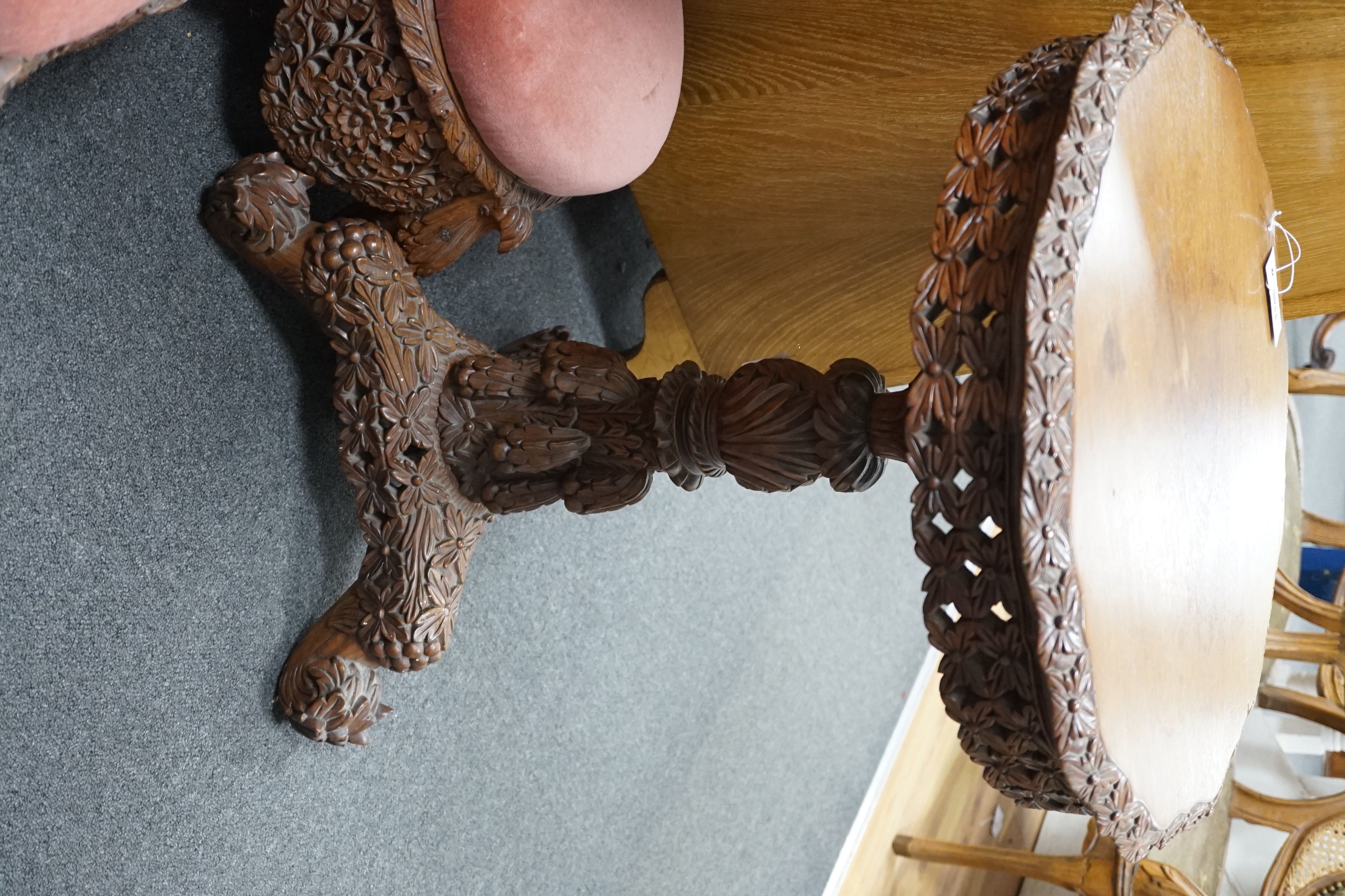 A Burmese carved hardwood circular occasional or centre table, diameter 57cm height 74cm, together with a similar side chair and foot stool